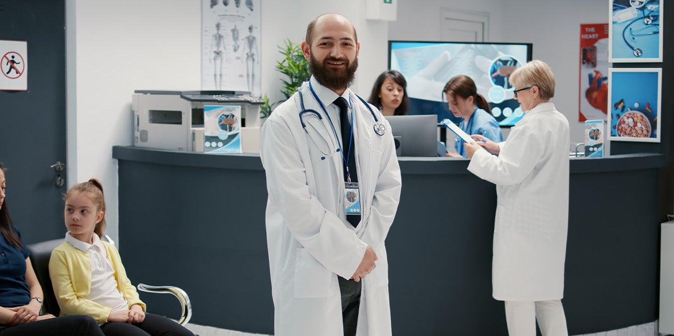 a male doctor with a beard working in a clinic